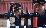 Policemen inspect seized bottles of fake wine. A Jiangxi restaurant owner was made to compensate a diner after he sold the man counterfeit liquor. Photo: Reuters