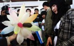 People check out condoms on display at a fair. Some sex shops in Beijing are selling cheap counterfeit condoms that cost a fraction the price of real ones. Photo: AFP
