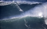 A surfer rides a big wave during a tow-in surfing session at the Praia do Norte or North beach, in Nazare, Portugal, Saturday, Nov. 29, 2014. A tow-in is a surf technique in which the athlete is towed into a large wave by a partner driving a jet-ski with an attached tow-line. (AP Photo/Francisco Seco)