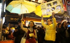 Protesters hold up a yellow umbrella and banners demanding true universal suffrage in Mong Kok. Photo: Chris Lau