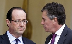 French President Francois Hollande speaks with Junior Minister for Budget Jerome Cahuzac. Photo: Reuters