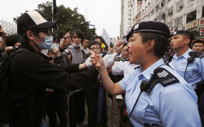 A protester argues with the police during a demonstration against the parallel traders in Yuen Long.  Photo: Reuters