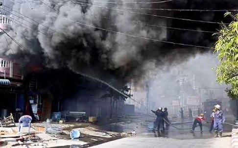 Firefighters try to extinguish a fire in during riots in Meiktila, central Myanmar, on Friday. Photo: EPA