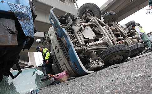 The out-of-control cement mixer ended up on its side after colliding with four other vehicles in Lei Yue Mun Road on Monday. Photo: David Wong