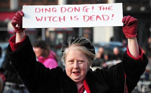 A reveller holds a sign to celebrate the death of Britain's former prime minister Margaret Thatcher, at a party in Brixton. Photo: AFP