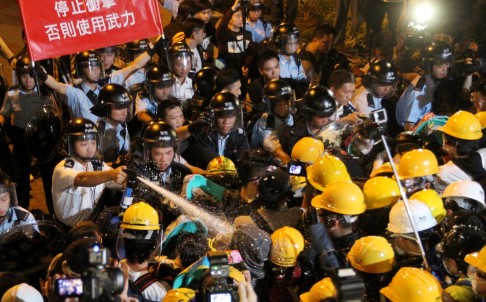 Police officers clash with pro-democracy protesters outside Central Government Offices on November 30. Photo: Edward Wong