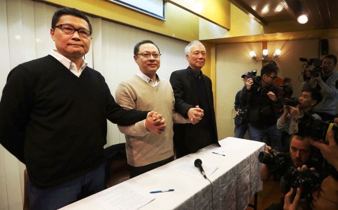 Occupy Central co-founders Dr Chan Kin-man, Benny Tai and Reverend Chu Yiu-ming hold hands at a press conference on Tuesday. Photo: Sam Tsang