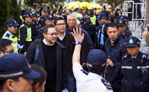 The Occupy Central trio of Benny Tai, Dr Chan Kin-man and the Reverend Chu Yiu-ming walk to Central Police Station yesterday. Photo: Reuters