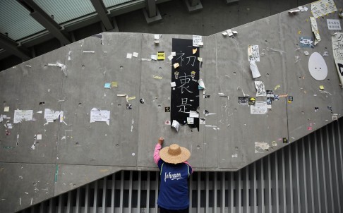 A worker cleans the area of the main pro-democracy protest site in Admiralty yesterday after the police clearance operation. Photo: AFP