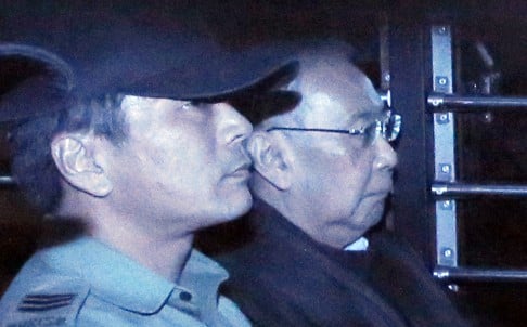 The long trial ends in shame for former chief secretary Rafael Hui (right) as he is taken away in a prison van following the verdict. Photo: AP
