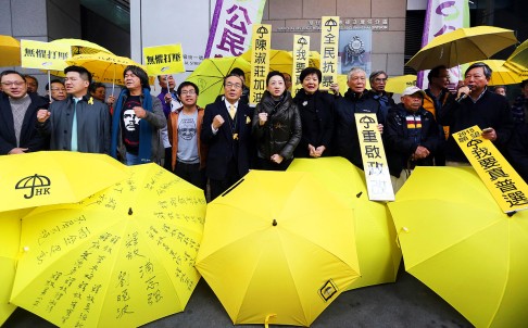 Tanya Chan (centre) reports to police at in Wan Chai. Police have asked activists for help with their investigation, but the activists don't plan to cooperate. Photo: Sam Tsang