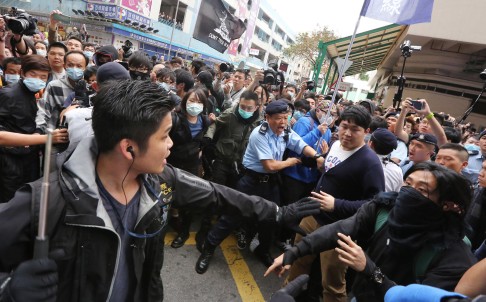 Police face off with protesters during yesterday's rally in Yuen Long, the latest in a series of protests aimed at traders from the mainland. Photo: Felix Wong