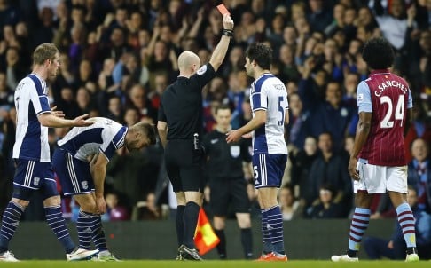 Referee Anthony Taylor sends off West Brom's Claudio Jacob. Colour psycghology suggests black shirts command discipline. Photo: Reuters 