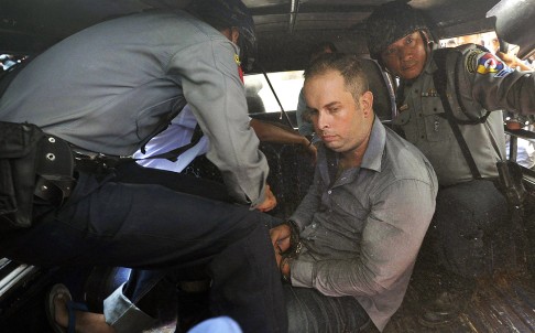 Bar manager Philip Blackwood, a New Zealander, sits in the back of a police van on his way to prison after sentencing yesterday. Photo: AFP