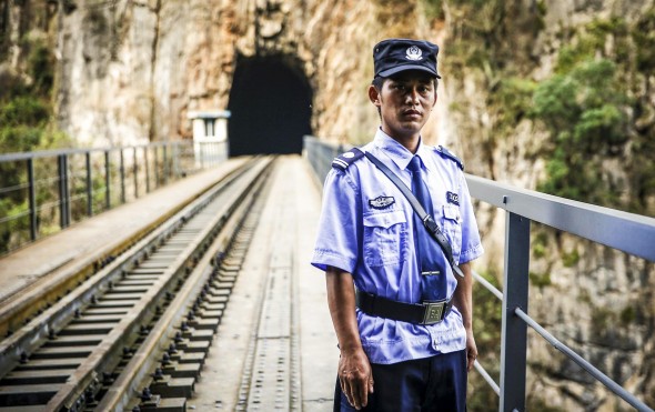 35-year-old Xiong Jun, a Miao nationality young man, guards the 100-year-old railway bridge. 