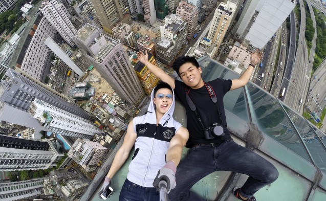 Daring “urban explorers” Daniel Lau, 23, and Dex Ng, 22, pose for a “selfie” on top of a Hong Kong skyscraper. Lau and Ng are part of the intrepid Exthetics team, along with 23-year-old Lawrence Tsui, whose video went viral on YouTube with almost three million views. Photo: Daniel Lau