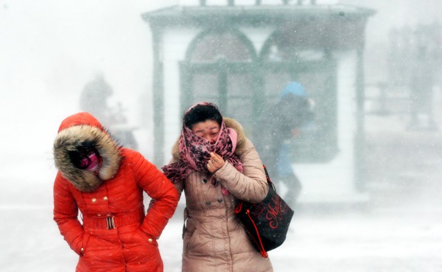 Two women wrap up warmly as they brave the icy wind and snow in Harbin in Heilongjiang province. This is not unusual for the northeastern region, but temperatures have also dropped sharply in many other places in China amid an intense winter monsoon. This is also the reason why Hong Kong is beginning to feel the chilly weather. Photo: CNS