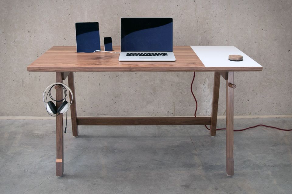 The Artifox Desk has slots for your devices and places to hold the cables.