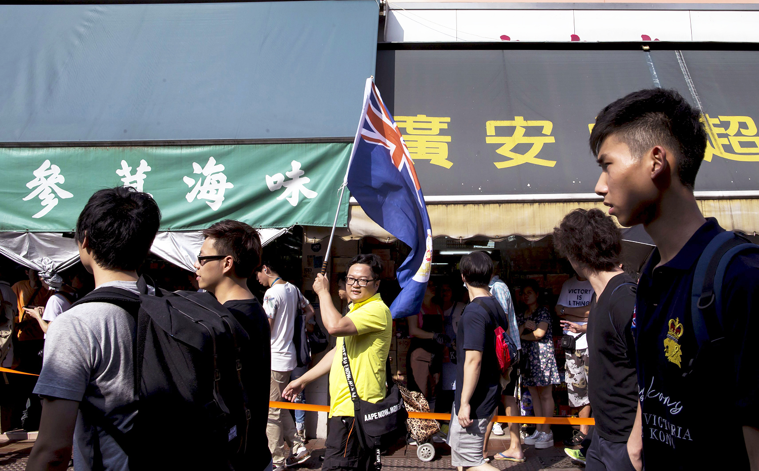 A protester carrying a Hong Kong colonial flag marches during a demonstration against mainland traders, near the border at Sheung Shui in Hong Kong. Photo: Reuters 