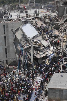 People rush to rescue workers trapped under rubble at the Rana Plaza building just moments after its collapse. Photo: Reuters