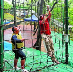 Negotiating the camp's cargo net course. Photo: Dickson Lee