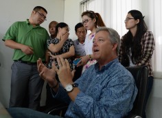 Chip Starnes is surrounded by government officials and trade union leaders during a briefing on Wednesday. Photo: AFP