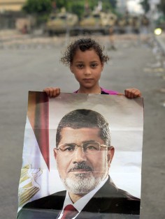 A youngster with a poster of Mohammed Mursi. Photo: AP