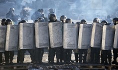 Riot police face a barricade in central Kiev. Photo: AP