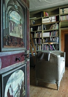 A Renaissance-era painted door opens the way to a world of books in one of the artist's studies.