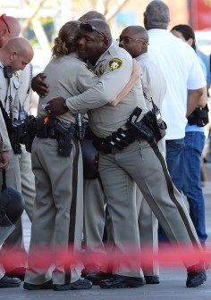 Las Vegas police hug near the scene of the shooting. Photo: AFP