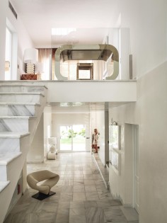 Stairs made of blanco Ibiza, a local marble, lead to the main living area.