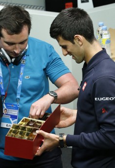 Top-seeded Novak Djokovic hands out chocolates at a media conference on the eve of the Australian Open. 