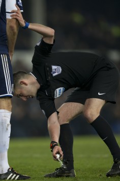 Referee Michael Oliver marks out a free kick during a English Premier League match between Everton and West Bromwich. Photo: AP