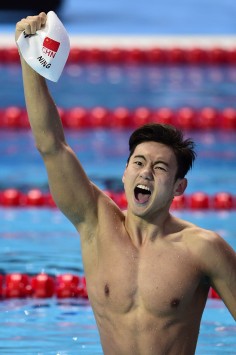 Ning Zetao celebrates winning gold in the men's 100m freestyle final in Kazan.   