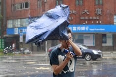 A man caught in the strong gusts in Taipei. Photo: AP