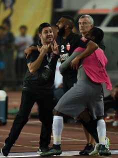 Salmin Khamis (centre) of Al Ahli is restrained from re-entering the pitch after his red card. Photo: Xinhua