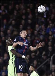 Paris Saint-Germain's Zlatan Ibrahimovic vies with Manchester City's Eliaquim Mangala for a high ball. Photo: AFP