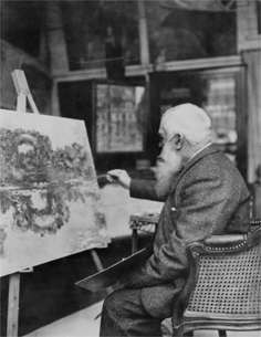 Monet touching up a painting in the studio, 1920.