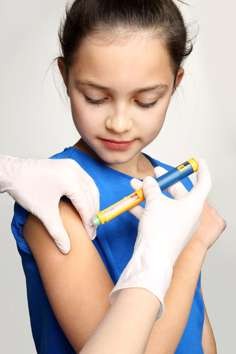 A young girl with diabetes is injected with insulin. The condition has been associated with brain differences.