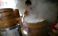 A chef at a steamed bun stall works hard to satisfy demand. Photo: SCMP Pictures