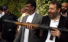 Chaudhry Aslam displays arms recovered during a Karachi police operation in January 2012. Photo: EPA