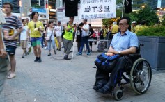 Max Leung is protesting from his wheelchair - as he has done since 1997. Photo: Ben Westcott