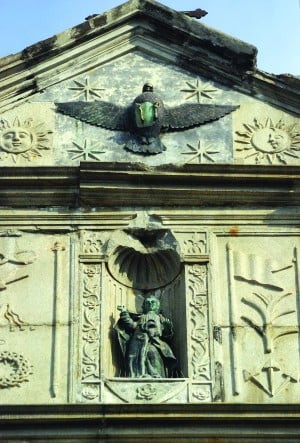 The dove sculpture at the top of the façade represents the Holy Spirit.