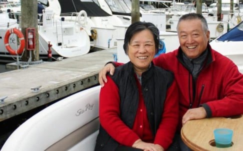 Mainland immigrants Chen Qianhong and husband Wei Fuqiang relax on their cruiser in the Vancouver Harbour marina. Photo: Ian Young
