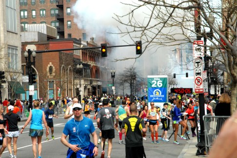 People run away from a blast during the Boston Marathon, in Boston. Photo: AP