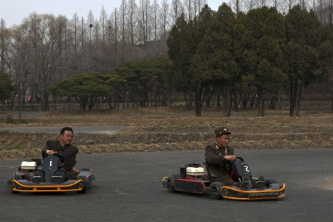 A North Korean soldier (right) races another man on a go-kart track at the Fun Fair in Pyongyang. Photo: AP