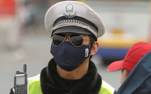 A policeman wears mask on a windy and dusty day at Tiananmen Square in Beijing. Photo: SCMP/Simon Song 