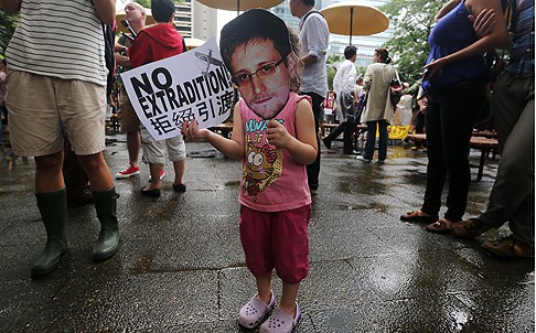 A child holds a cut-out of Edward Snowden at the rally. Photo: Sam Tsang
