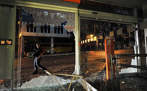 A bank is vandalised by demonstrators during a protest against corruption. Photo: AFP