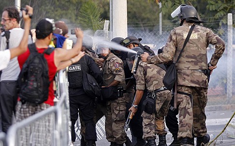 Demonstrators clash with police spraying tear gas in the vicinity of Mineirao Stadium in Belo Horizonte. Photo: Reuters